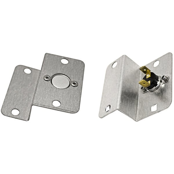 A metal plate with a round metal piece and two screws.