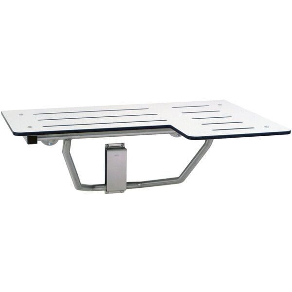 A white rectangular Bobrick folding shower seat on a table.