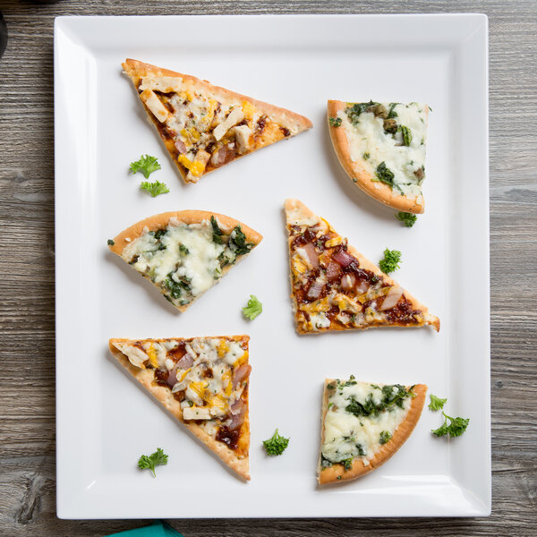 A white rectangular melamine serving platter with four slices of pizza on it.
