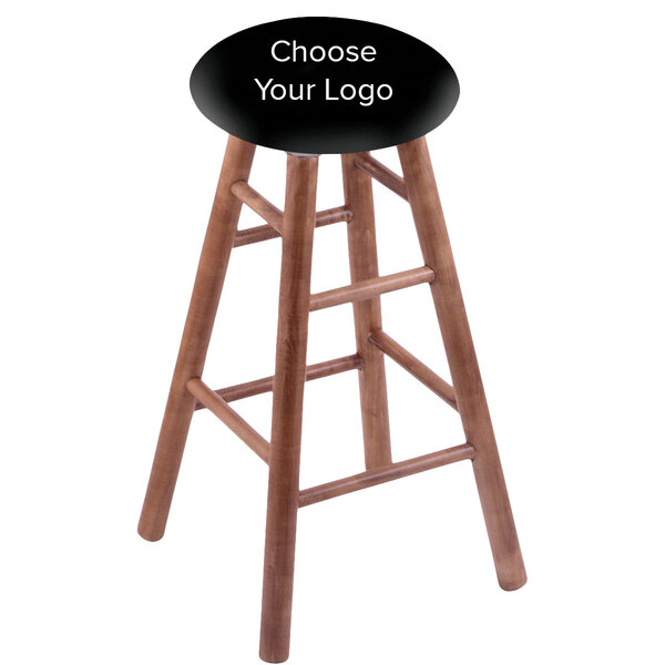 A Holland Bar Stool wooden bar stool with a black seat.