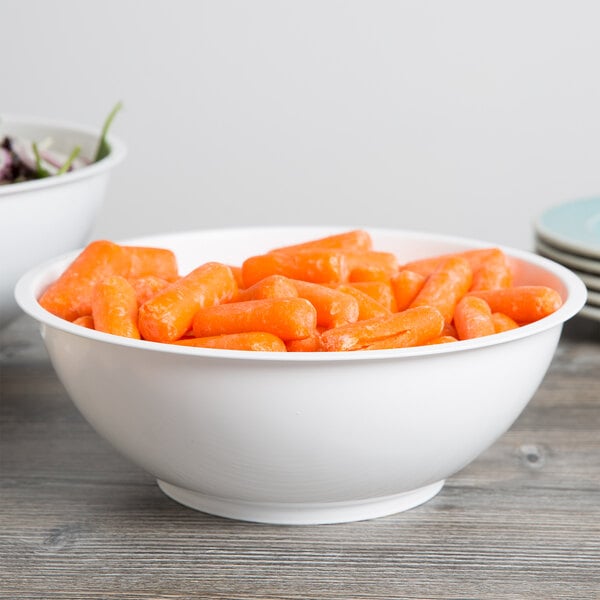 A white Fineline high profile plastic catering bowl filled with baby carrots and salad.