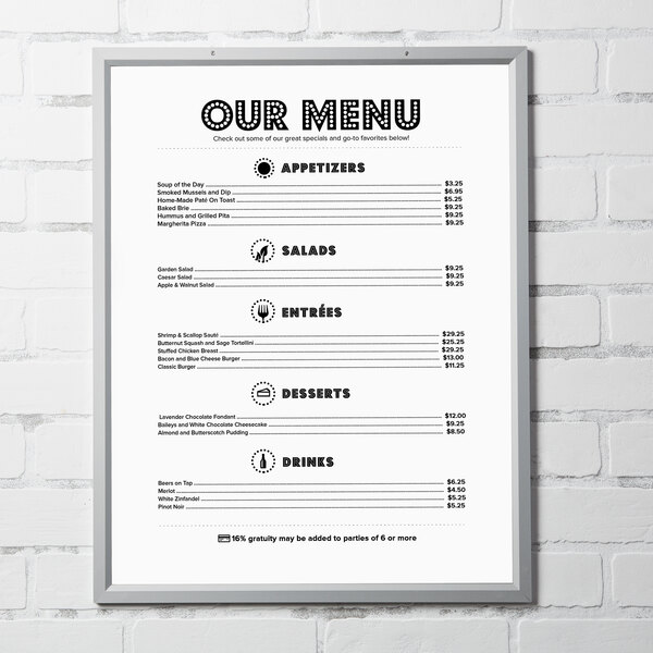 An Aarco Insta Frame holding a menu on a brick wall with black and white text.