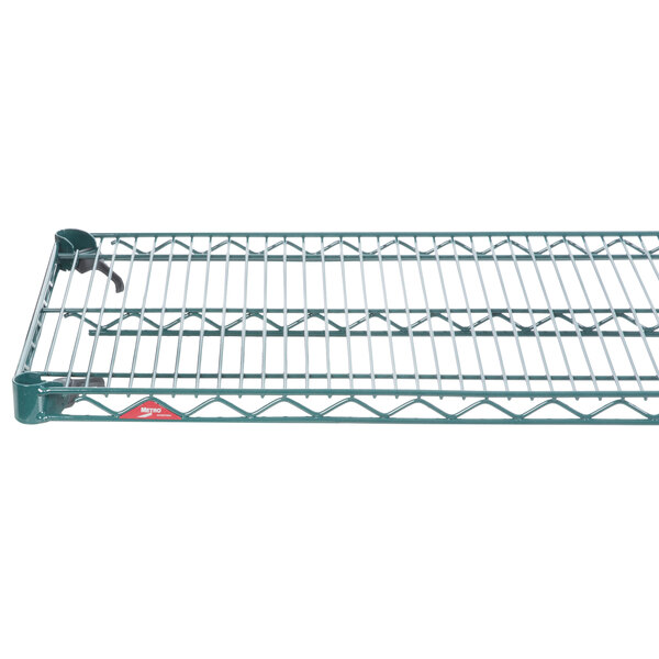 A Metroseal wire shelf on a metal railing.