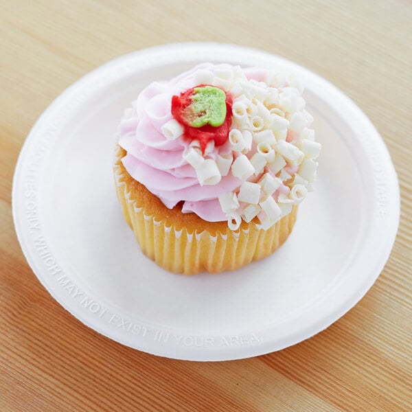 A cupcake with pink frosting and marshmallows on a white Eco-Products compostable sugarcane plate.