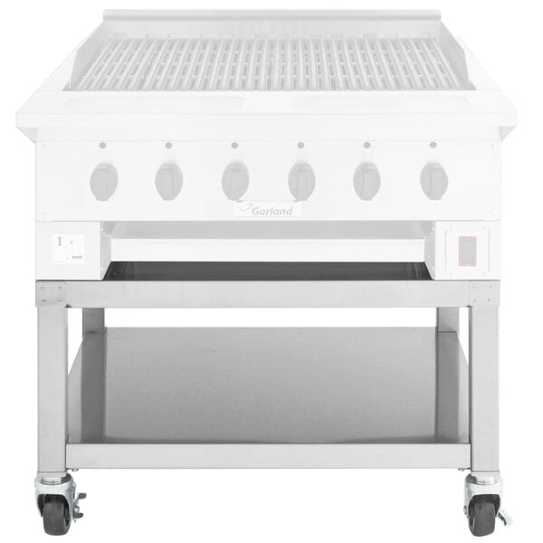 A Garland stainless steel grill stand with casters.