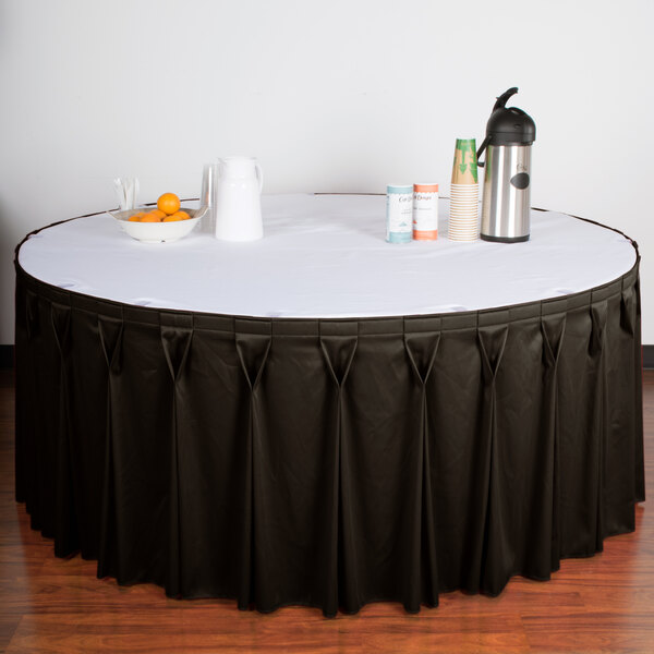 A table with a charcoal Snap Drape table skirt with Velcro clips.