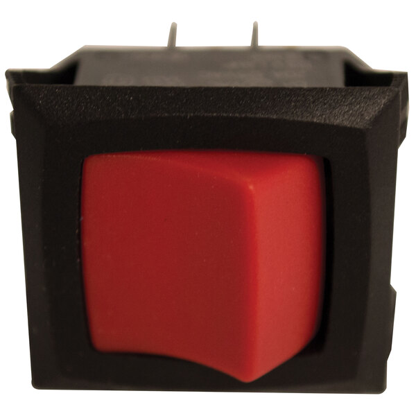 A close up of a red push button switch on a black square.