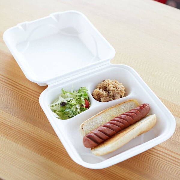 A white Eco-Products compostable 3-compartment takeout container with a hot dog and salad.