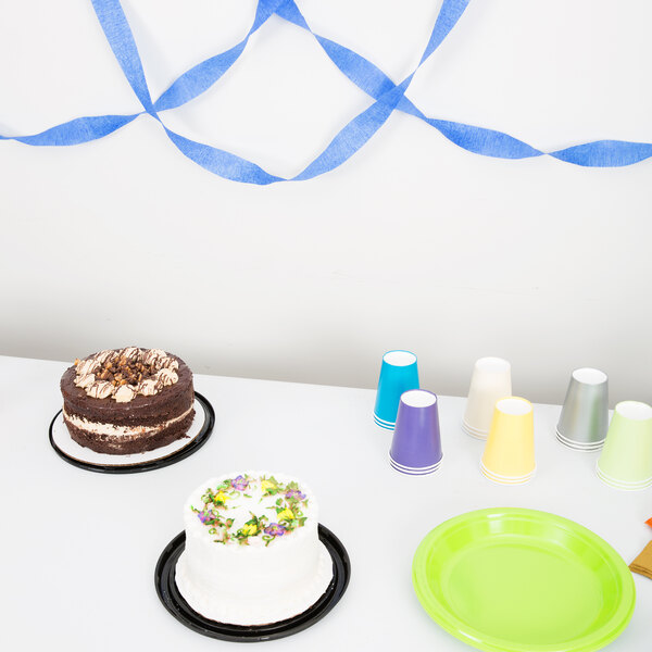 A table with plates and cups with Cobalt Blue Streamer Paper on it.