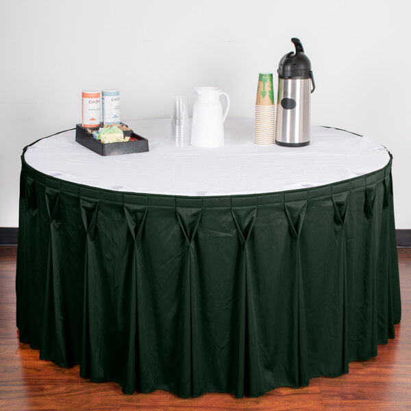 A table with a jade Snap Drape Wyndham table skirt with Velcro clips on it.