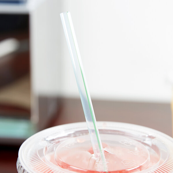 A GreenStripe compostable plastic straw in a plastic cup.