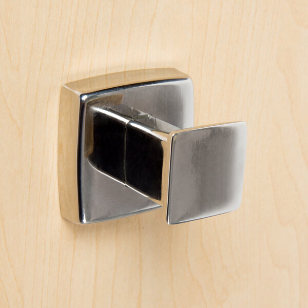 A close-up of a Bobrick metal robe hook with a bright polished finish.