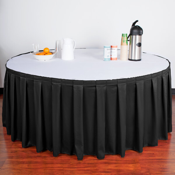 A table with a black Snap Drape table skirt.
