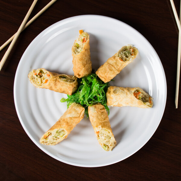A white GET Milano melamine plate with fried spring rolls and green seaweed.