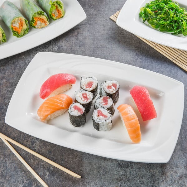 A Libbey Royal Rideau white porcelain plate with sushi and rolls on it.