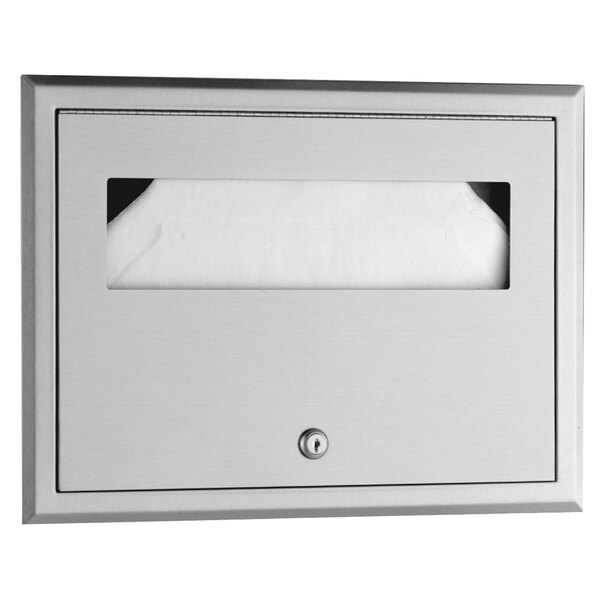 A Bobrick stainless steel recessed seat-cover dispenser with white paper.