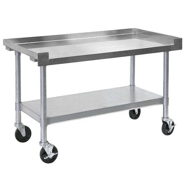 A Bakers Pride stainless steel metal table with wheels.