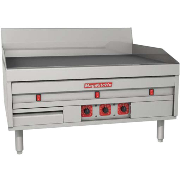 A MagiKitch'n electric countertop griddle with thermostatic controls and knobs on a white table.
