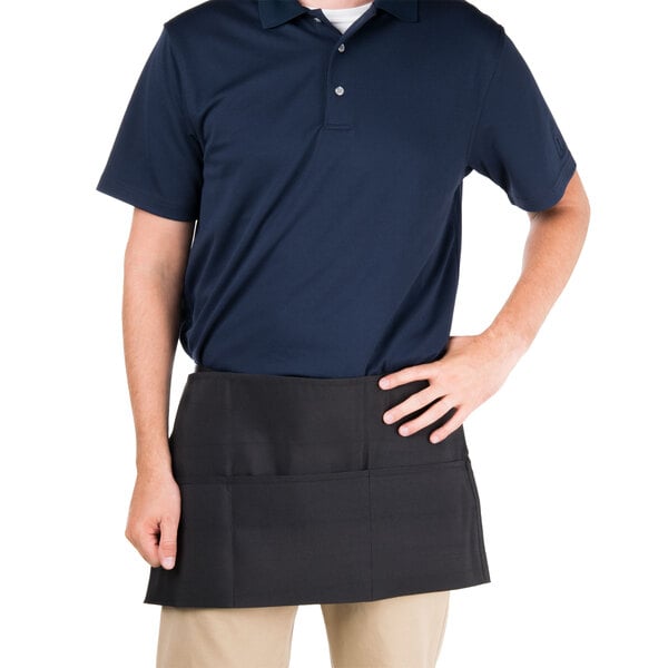 A man wearing a black Chef Revival waist apron with three pockets.