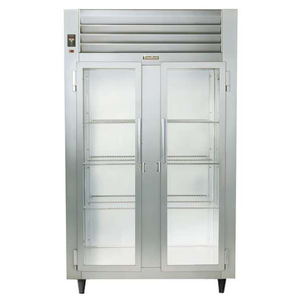 A Traulsen stainless steel reach-in refrigerator with glass doors and shelves.