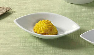 A CAC Super White porcelain bowl with yellow food in it.