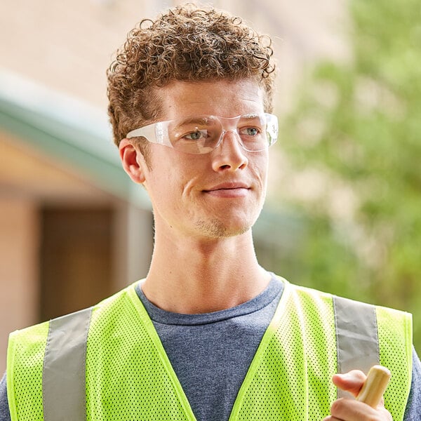 A man wearing Cordova safety glasses and a yellow vest.