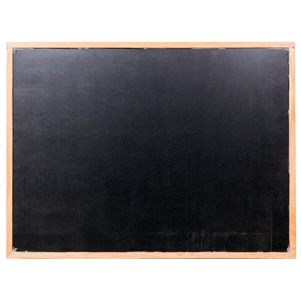 An Aarco black marker board with an oak frame.