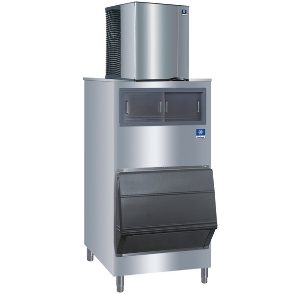 A stainless steel Manitowoc ice machine with a large stainless steel panel on top.
