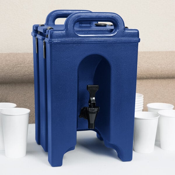A navy blue Cambro insulated beverage dispenser with a black spigot and white cups.
