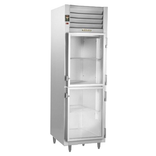 A Traulsen narrow reach-in refrigerator with glass half doors and an empty white shelf.
