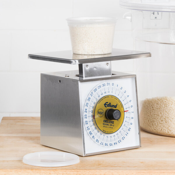 An Edlund Premier Series portion scale on a counter with a bowl of rice in it.