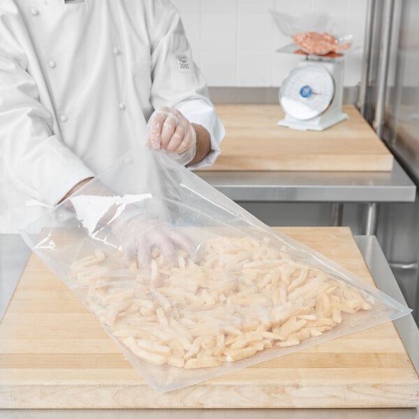 A chef using an ARY VacMaster vacuum packaging bag to prepare food.