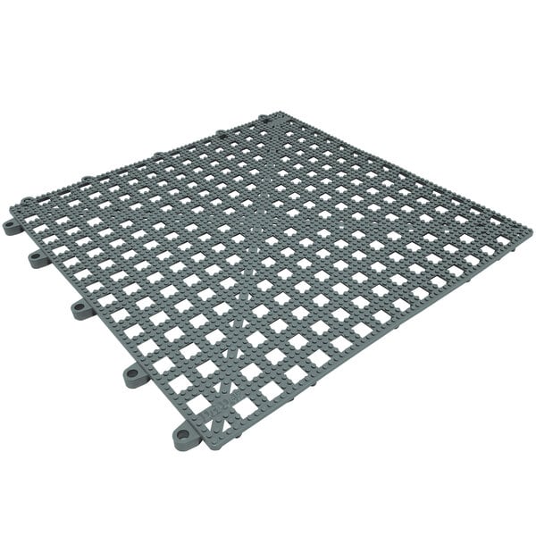A grey plastic grid floor mat with holes.