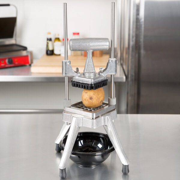 A Nemco Easy Chopper  sits on a table in a professional kitchen.