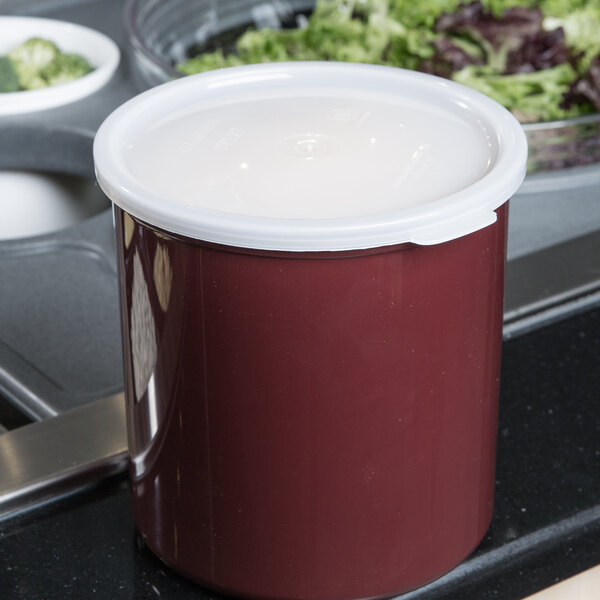 A red Cambro round crock with a white lid.