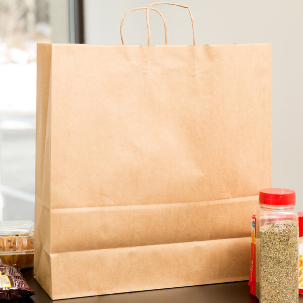 A Duro natural kraft paper shopping bag on a table with a couple of spices inside.