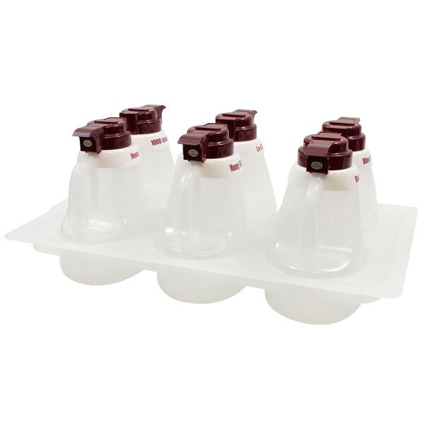 A Tablecraft salad dressing dispenser set with four maroon and white containers with red caps on a tray.