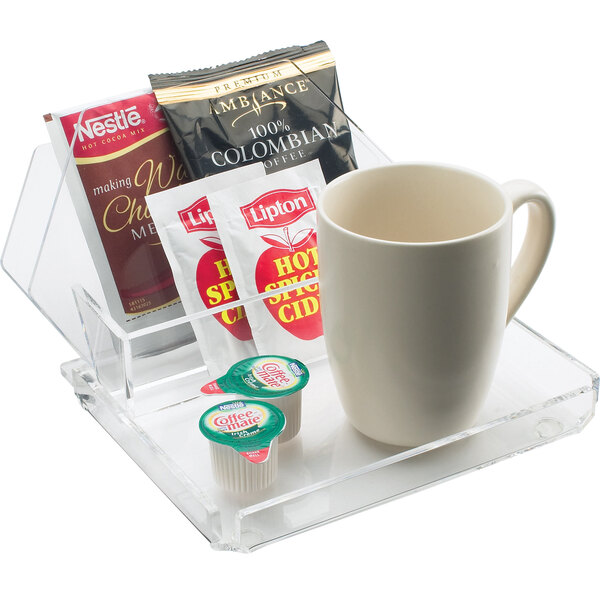 A clear Cal-Mil acrylic tray with coffee and tea cups and packets.