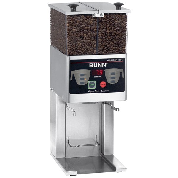 A Bunn commercial coffee grinder with double hoppers filled with coffee beans.