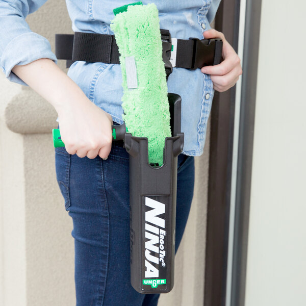 A woman wearing a green Unger ErgoTec Ninja Bucket-On-A-Belt.