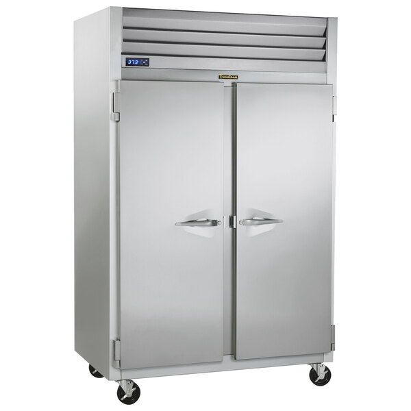 A large silver Traulsen pass-through refrigerator with two doors.