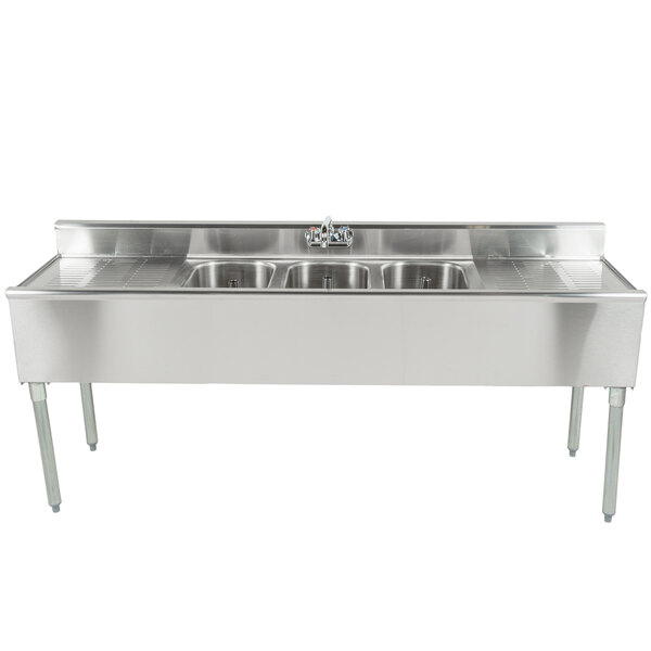 An Eagle Group stainless steel underbar sink with three bowls, two drainboards, and a splash mount faucet.