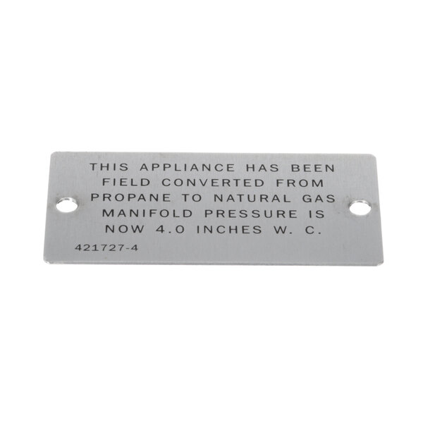 A rectangular metal plate with the text "This appliance has been prepared to provide natural gas" on it.