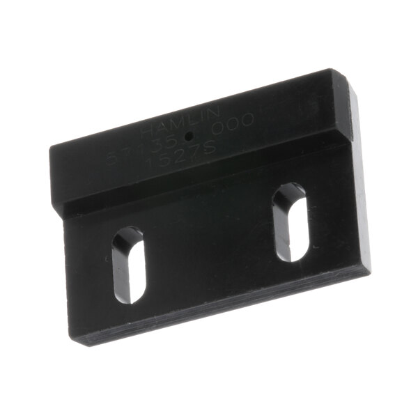 A black plastic rectangular TurboChef magnet with two holes.