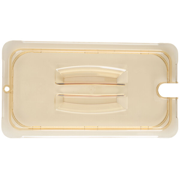 A Carlisle amber plastic container lid with a handle and spoon notch.