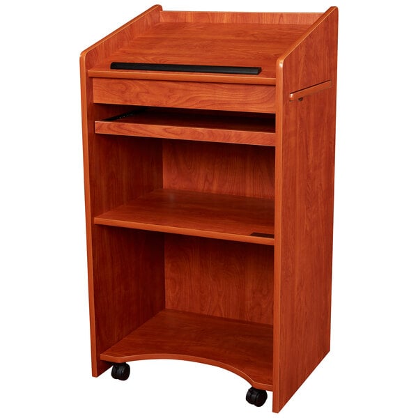 A wooden Oklahoma Sound lectern with a black shelf and drawer.