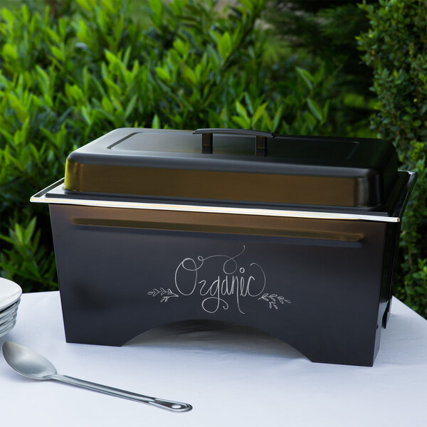A black rectangular Sterno chafing dish with a lid on a white surface.