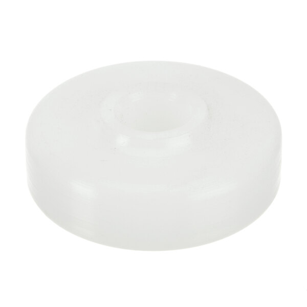 A white plastic round object with a hole.