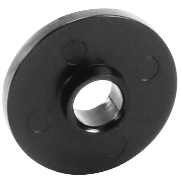 A black circular plastic disc with holes.