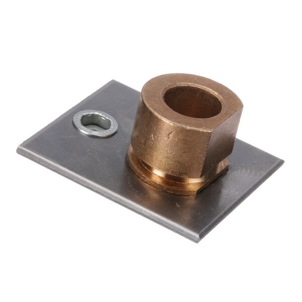 A brass US Range door bushing plate with a hole in it.